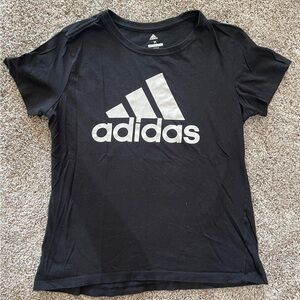 Women’s Black Adidas golf tee.